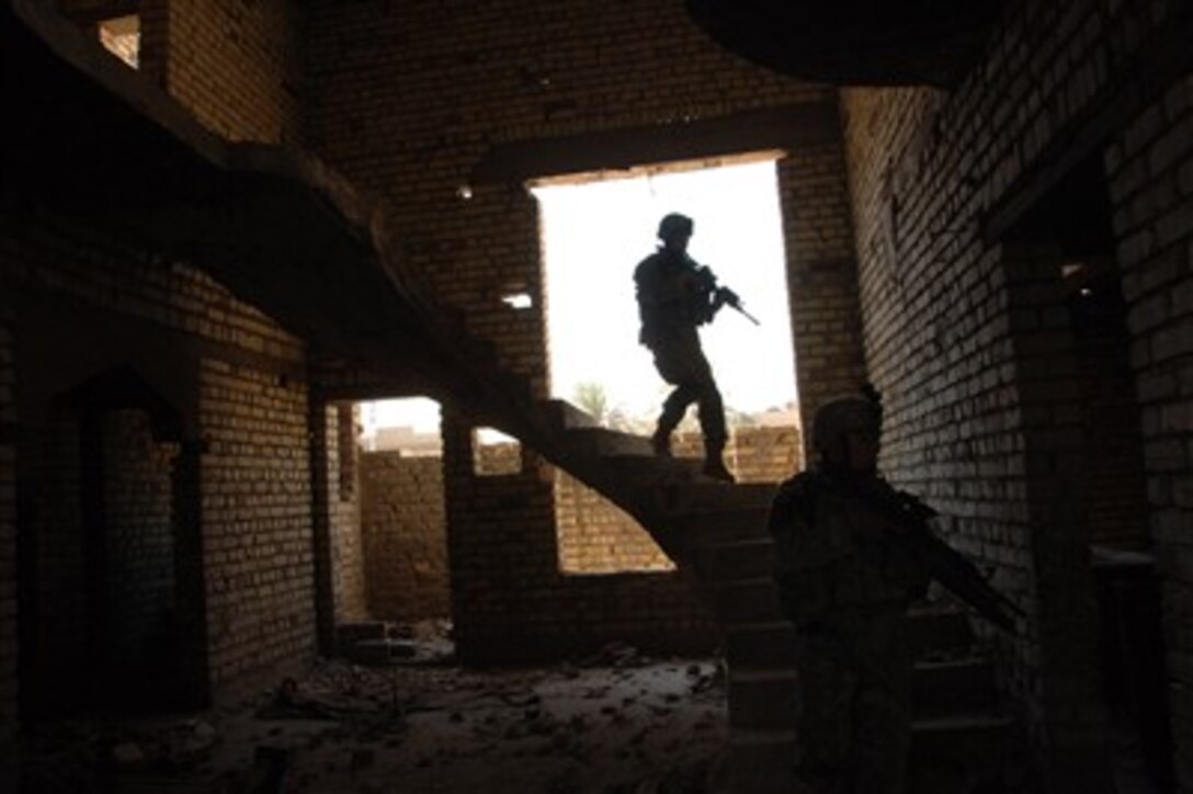 U.S. Army soldiers clear a house during a patrol in the Al Rashid Province of Baghdad, Iraq, on Sept. 5, 2007.  The soldiers are assigned to Alpha Troop, 1st Battalion, 4th Cavalry Regiment, 4th Infantry Brigade Combat Team, 1st Infantry Division.  
