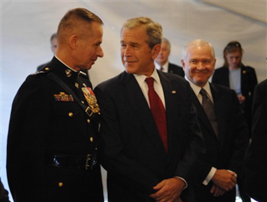 Outgoing Chairman of the Joint Chiefs of Staff Gen. Peter Pace (left), U.S. Marine Corps, shares a light moment with President George W. Bush as Secretary of Defense Robert M. Gates looks on during an Armed Forces Hail and Farewell ceremony at Fort Myer, Va., on Oct. 1, 2007, for Pace and incoming Chairman of the Joint Chiefs of Staff Adm. Mike Mullen, U.S. Navy.  