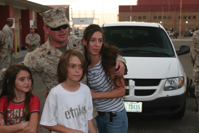 Gunnery Sgt. Aaron Viscovi, Com?bat Logistics Company 16 mainte?nance chief, spends time with his wife Nicole, his daughter Alexis and his son Josh after recently returning from Iraq. Viscovi, was selected to deploy with the 1st Marine Expeditionary Force bor?der transition team because of his logistic capabilities and job skills.