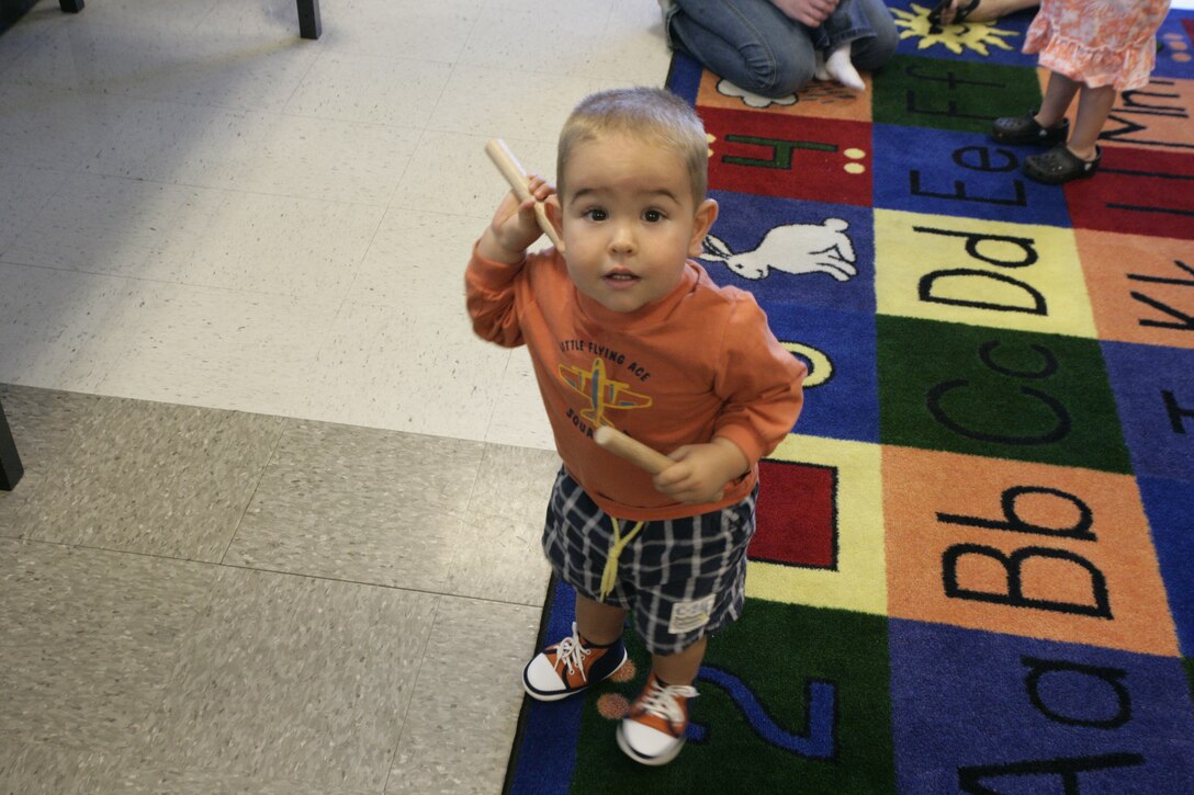 Levi Free, 18 months, plays with rhythm sticks during a kindermusik class Wednesday. The rhythm sticks help the children develop their motor skills and a steady musical beat.