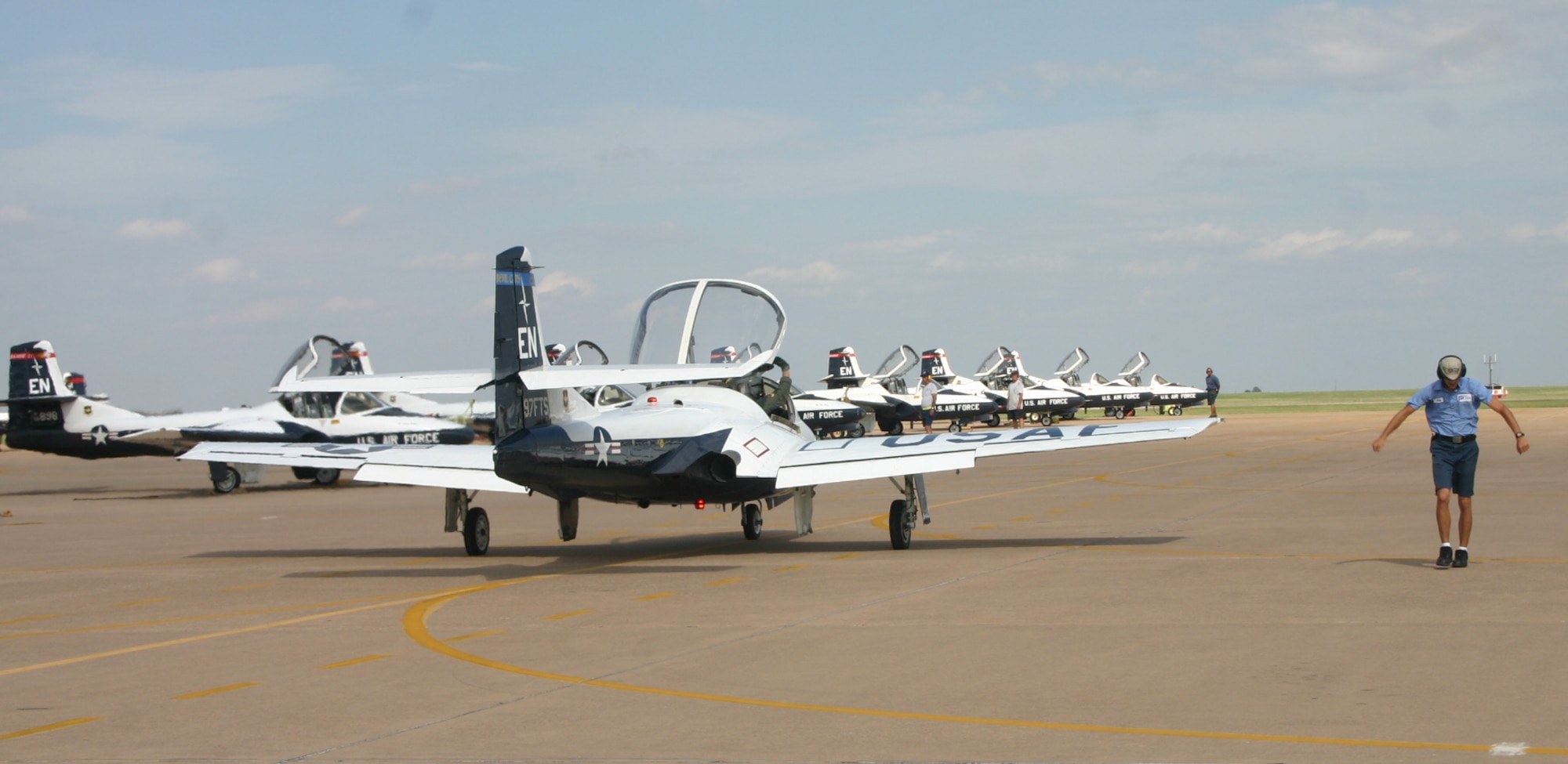 Crew chief Michael King, right, signals to the lead jet as it prepares for its four-ship formation flight Oct. 2.  This will be the last such formation flight at Sheppard for the T-37 Tweet as the transition to the T-6 Texan begins in 2008. (U.S. Air Force photo/Staff Sgt. Tonnette Thompson)