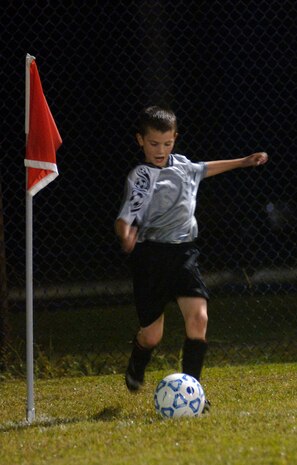 Tyler Eisert, 9, son of Staff Sgt. Justin Eisert, corner kicks the ball to a teammate to continue the game Oct. 2.  (U.S. Air Force photo/ Staff Sgt. April Quintanilla)