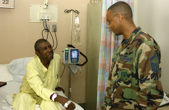 Senior Master Sgt. Curlie Alexander, 437th Logistics Readiness Squadron Top III member, meets with retired Army Staff Sgt. Jackie Wicks during the Top III's quarterly visit to the Charleston Veterans Administration Hospital in downtown Charleston. Monday. The Charleston AFB Top III collects donated health and comfort items from the base populace and brings them to veterans receiving treatment at the VA Hospital (U.S. Air Force photo/Tech. Sgt. Paul Kilgallon)