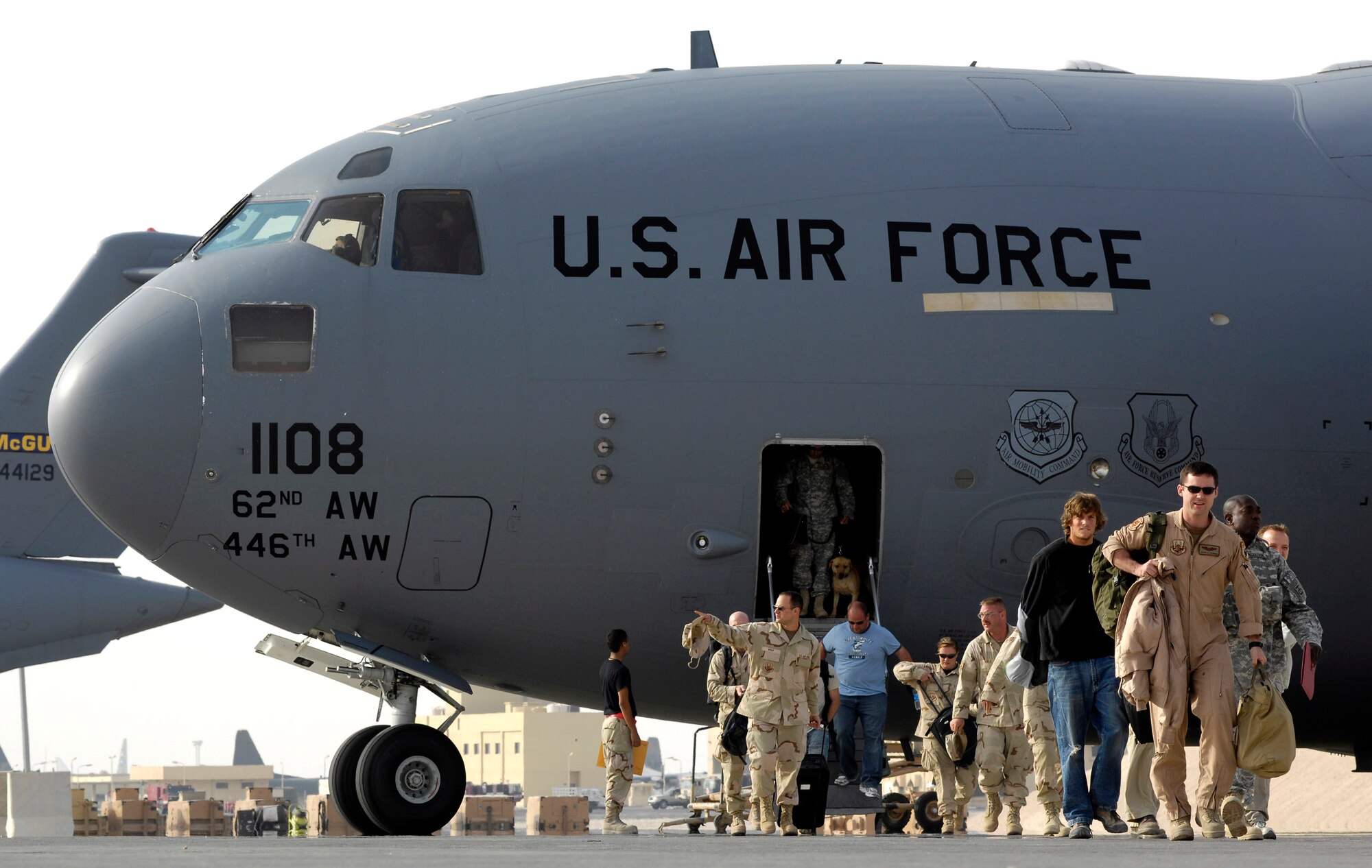 Passengers depart a C-17 Globemaster III in Southwest Asia Oct. 3.   September was a record-breaking month for the air component mobility fleet.  For the first time, the air mobility fleet transported more than 115,000 passengers and more than 20,000 short tons of cargo in, out and around the U.S. Central Command area of responsibility. (U.S. Air Force photo/Staff Sgt. Brian Ferguson)