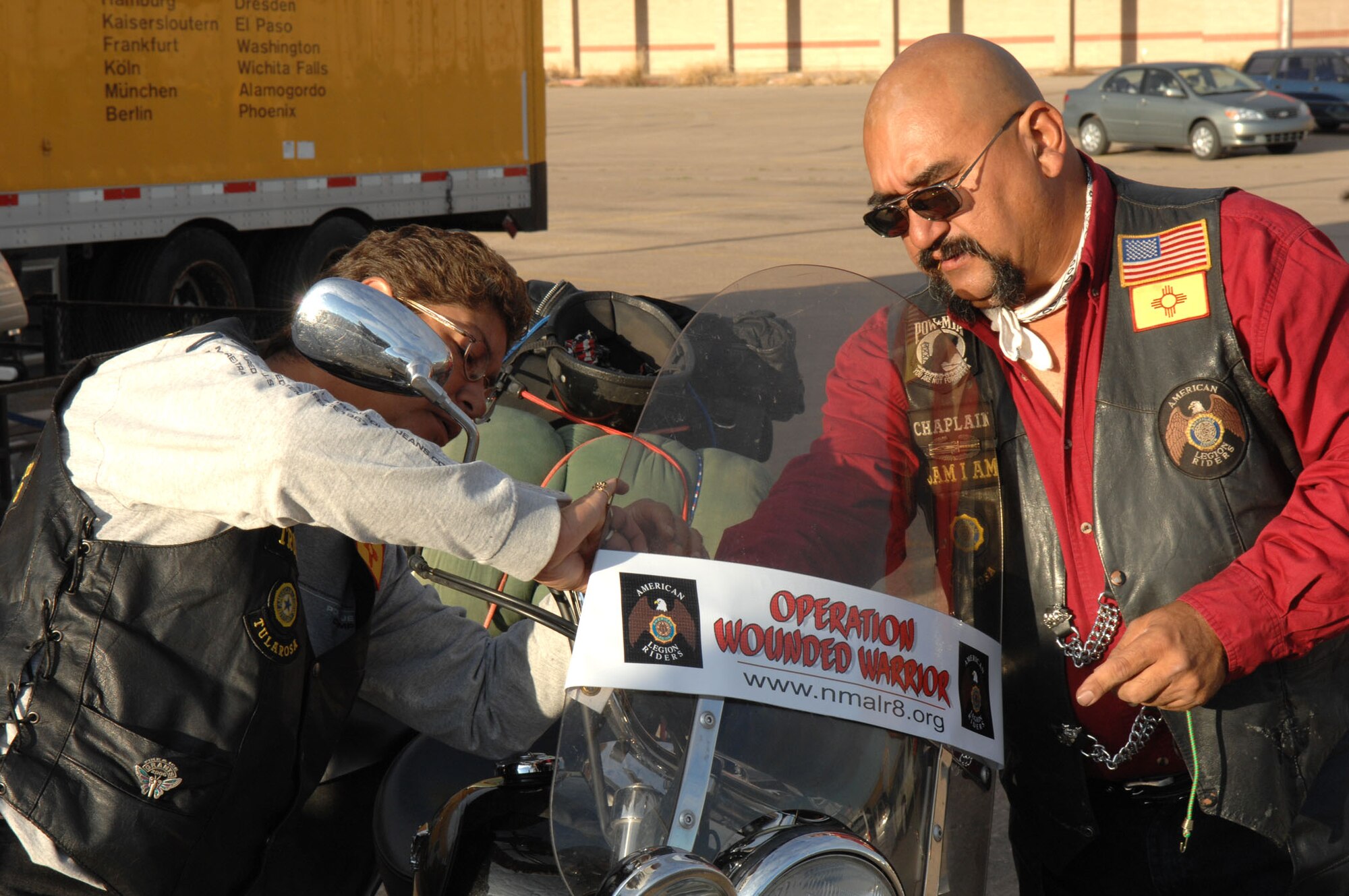 Two members of the American Legion Riders get ready for the road trip to Brooke Army Medical Center, San Antonio. The riders brought comfort and personal items and monetary donations to the center for Operation Wounded Warrior. (U.S. Air Force photo/Airman 1st Class John Strong)