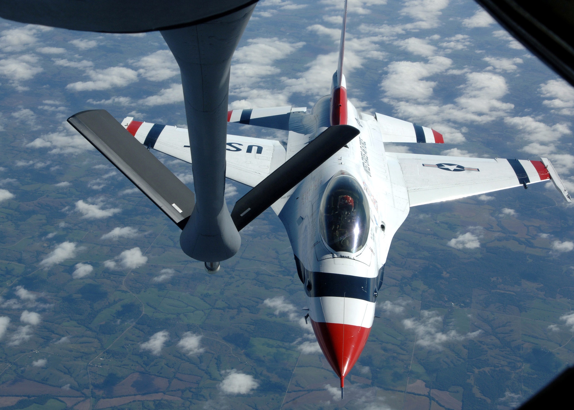 An Air Force Thunderbirds pilot pulls away after taking on fuel from a KC-135 Stratotanker Oct. 1 over the Midwest during a refueling mission. The Thunderbirds are the Air Force's premier demonstration squadron. The F-16 Fighting Falcon team represents the Air Force throughout the nation and abroad. The KC-135 is assigned to the 319th Air Refueling Wing tanker from Grand Forks Air Force Base, N.D. (U.S. Air Force photo/Airman 1st Class Chad M. Kellum)

