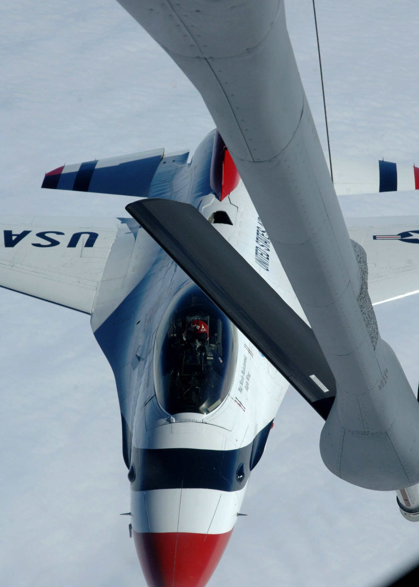 An Air Force Thunderbirds pilot pulls away after taking on fuel from a KC-135 Stratotanker Oct. 1 over the Midwest during a refueling mission. The Thunderbirds are the Air Force's premier demonstration squadron. The F-16 Fighting Falcon team represents the Air Force throughout the nation and abroad. The KC-135 is assigned to the 319th Air Refueling Wing tanker from Grand Forks Air Force Base, N.D. (U.S. Air Force photo/Airman 1st Class Chad M. Kellum)
