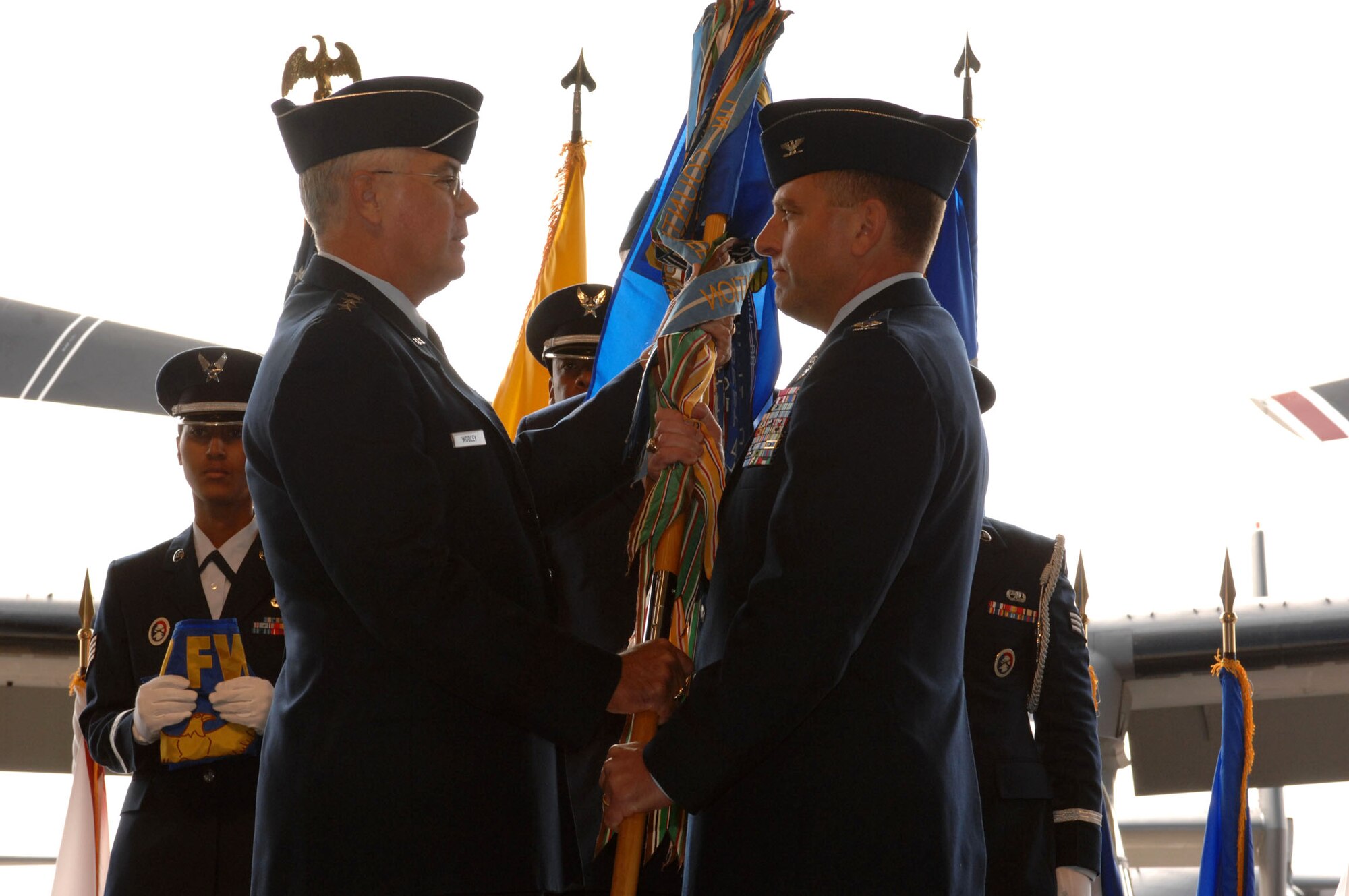 Lt. Gen. Michael Wooley (left) passes the guidon of the newly formed 27th Special Operations Wing to the new commander, Col. Tim Leahy, during a ceremony Oct. 1 at Cannon Air Force Base, N.M. General Wooley is the Air Force Special Operations Command commander. (U.S. Air Force photo/Airman 1st Class Evelyn Chavez) 
