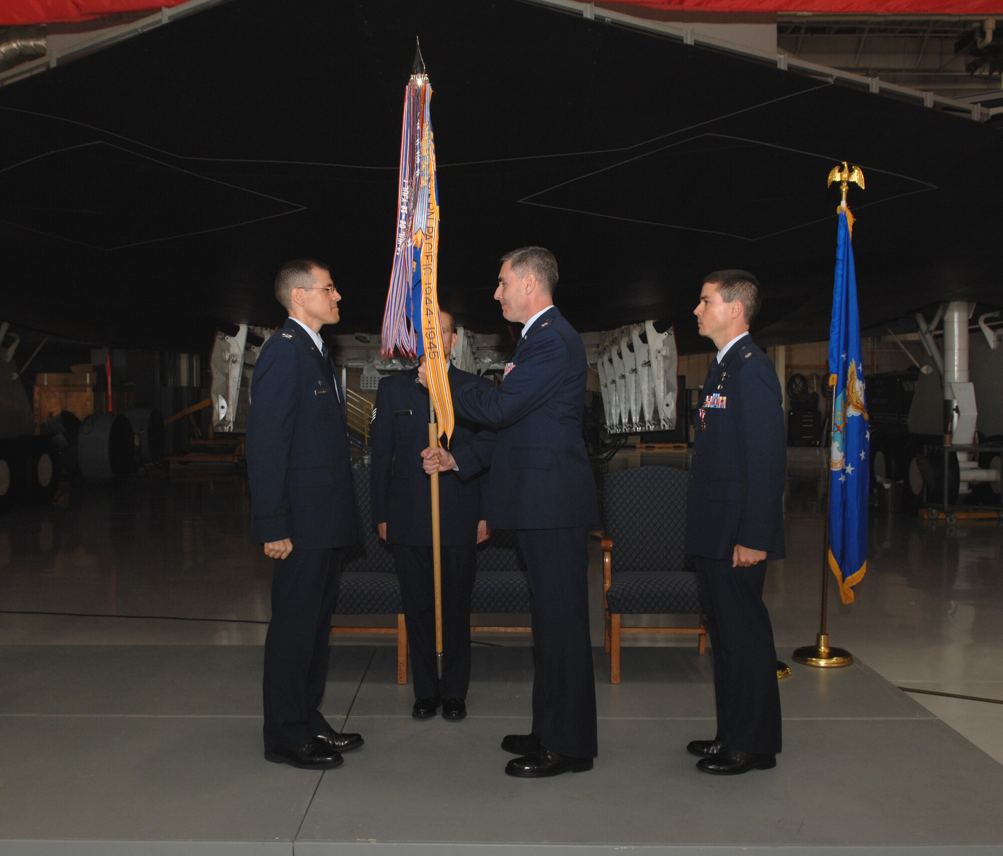 WHITEMAN AIR FORCE BASE, Mo. – (Center) Col. John Vitacca, 393d Bomb Squadron commander, receives the guidon of the 393d BS from Col. Thomas Bussiere (left), 509th Operations Group commander, during a change-of-command ceremony Oct. 3. Colonel Vitacca, who was previously assigned to the 509th Operations Support Squadron here, replaces Col. Paul Tibbets (right), who moves on to Brussels, Belgium, where he will be the Chief of the Nuclear, Biological and Chemical Policy Branch at NATO Headquarters. (U.S. Air Force photo/Airman 1st Class Stephanie Clark)