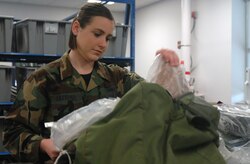 Airman 1st Class Megan Latteyer, 437th Logistics Readiness Squadron war readiness technician, inspects the contents of a C-bag prior to the mobility processing line Tuesday at the mobility processing center on base. (U.S. Air Force photo/Airman Melissa White)