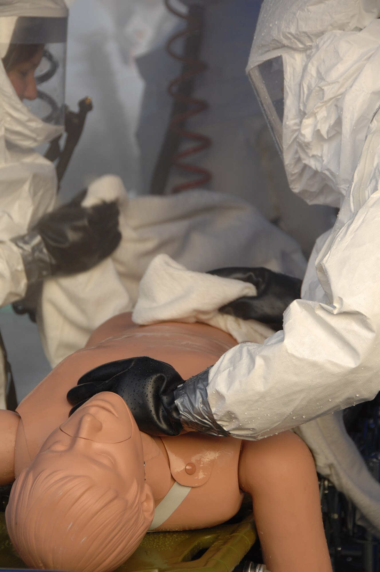 EIELSON AIR FORCE BASE, Alaska --  Members of the 354th Medical dry off a victim after decontaminating them during a training exercise Sept. 27th located by the 354th Medical Clinic. The Air Force Surgeon General's office asked each Air Force installation to go through a type of training exercise, Eielson simulated a pandemic disease outbreak.  (U.S. Air Force photo by Airman 1st Class Christopher Griffin)
