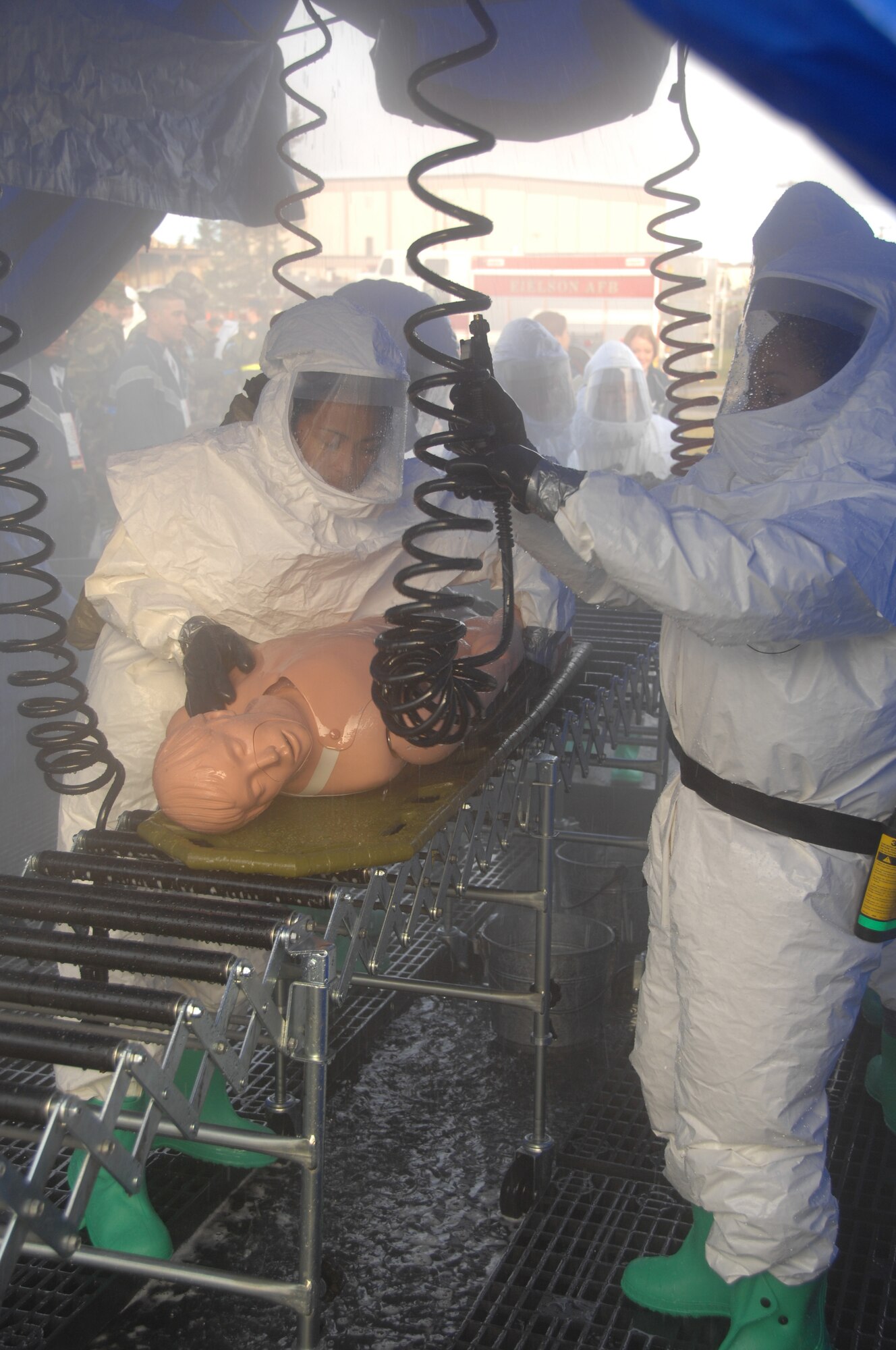 EIELSON AIR FORCE BASE, Alaska -- Members of the 354th Medical decontaminate a victim during a training exercise Sept. 27th located by the 354th Medical Clinic. The Air Force Surgeon General's office asked each Air Force installation to go through a type of training exercise, Eielson simulated a pandemic disease outbreak.  (U.S. Air Force photo by Airman 1st Class Christopher Griffin)