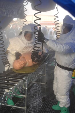 EIELSON AIR FORCE BASE, Alaska -- Members of the 354th Medical decontaminate a victim during a training exercise Sept. 27th located by the 354th Medical Clinic. The Air Force Surgeon General's office asked each Air Force installation to go through a type of training exercise, Eielson simulated a pandemic disease outbreak.  (U.S. Air Force photo by Airman 1st Class Christopher Griffin)