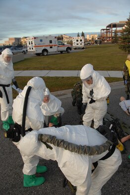 EIELSON AIR FORCE BASE, Alaska --  Members of the 354th Medical Group discuss the injuries of a victim during a training exercise Sept. 27th located by the 354th Medical Clinic. The Air Force Surgeon General's office asked each Air Force installation to go through a type of training exercise, Eielson simulated a pandemic disease outbreak.  (U.S. Air Force photo by Airman 1st Class Christopher Griffin)