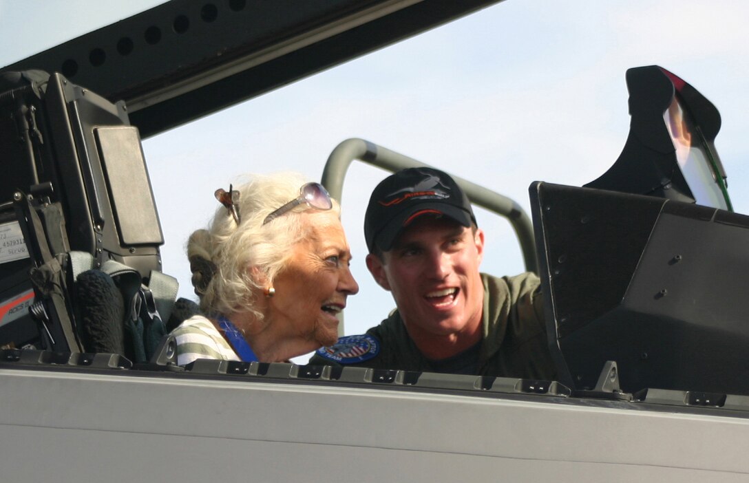LANGLEY AIR FORCE BASE, Va. -- Ms. Betty Blake, one of the original Women Air Force Service Pilots who served during World War II, watches as Capt. Leo Lemelson, F-22A Aerial Demonstration Team safety observer, explains the inner workings of the Raptor during the Ohio air show Sept. 30. According to Ms. Blake’s son, George, she started flying at 14 without her parents’ knowledge because they wouldn’t have allowed her to be a pilot. Ms. Blake spent all four years of the war as a transport pilot ferrying 36 different types of aircraft including the P-51. Ms. Blake was one of 51 legendary aces, veterans, WASPs and crew chiefs honored at The Gathering of Mustangs and Legends in Columbus, Ohio, Sept. 27-30. (U.S. Air Force photo/Capt. Tracy Bunko)