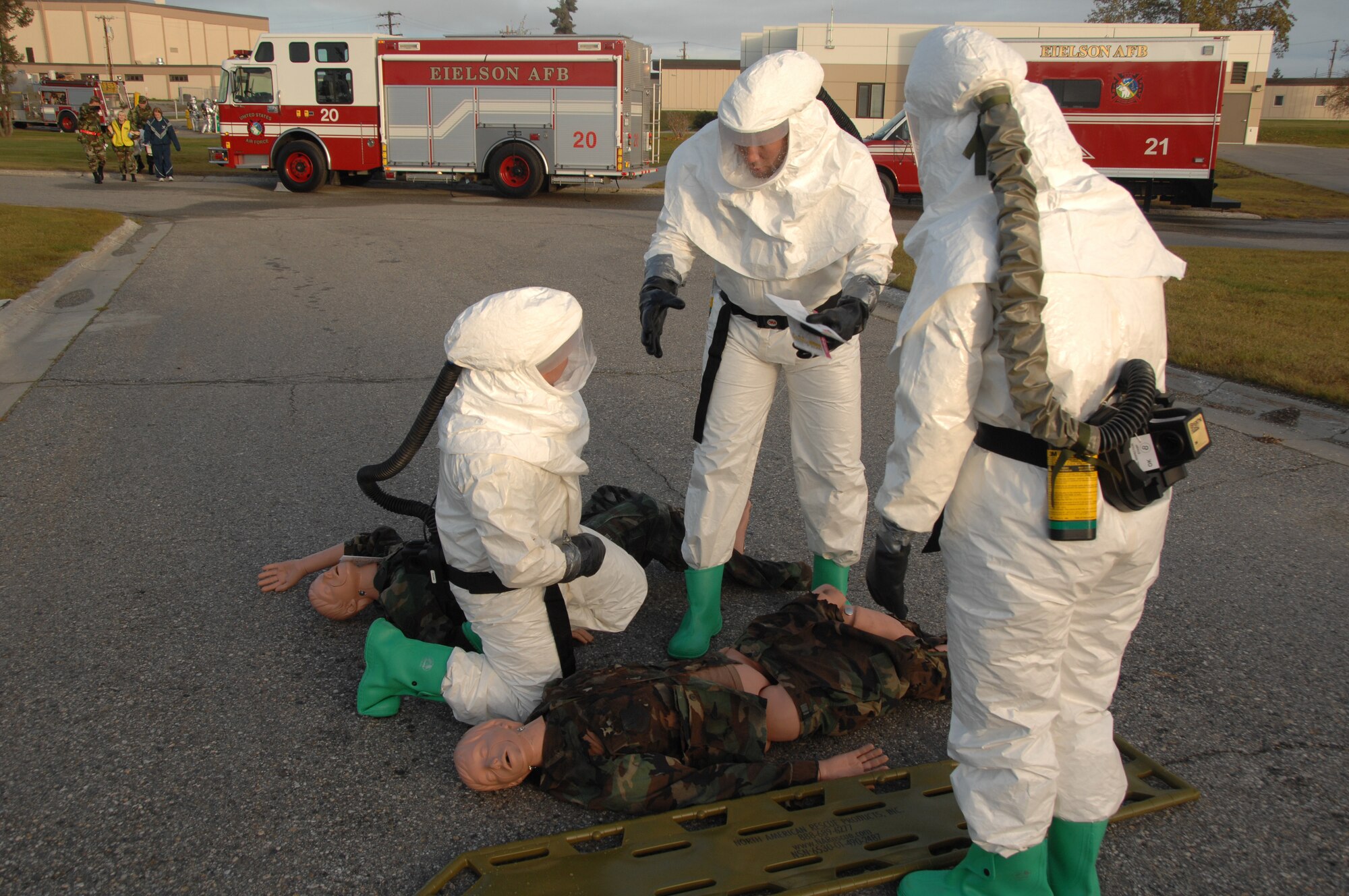EIELSON AIR FORCE BASE, Alaska --  Members of the 354th Medical Group discuss the injuries of a victim during a training exercise Sept. 27th located by the 354th Medical Clinic. The Air Force Surgeon General's office asked each Air Force installation to go through a type of training exercise, Eielson simulated a pandemic disease outbreak.  (U.S. Air Force photo by Airman 1st Class Christopher Griffin)