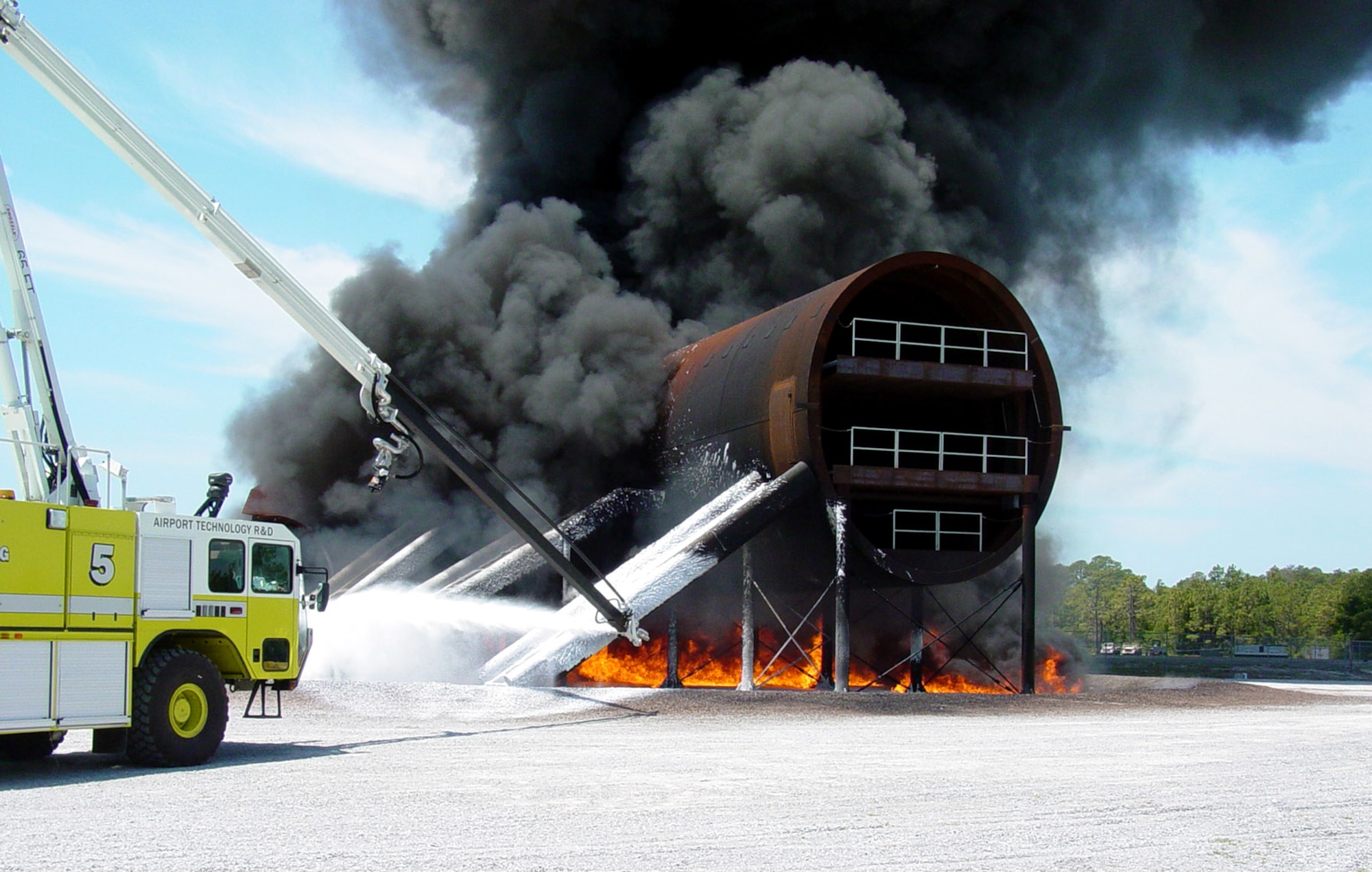 Engineers conduct a JP-8 pool fire using 250 gallons of fuel to test temperature sensors on the new large aircraft mockup Sept. 25 at Tyndall Air Force Base, Fla. Air Force Research Laboratory officials, working with the Federal Aviation Administration, developed the mockup to research firefighting and rescue techniques in today's larger, multi-deck aircraft. (U.S. Air Force photo) 

