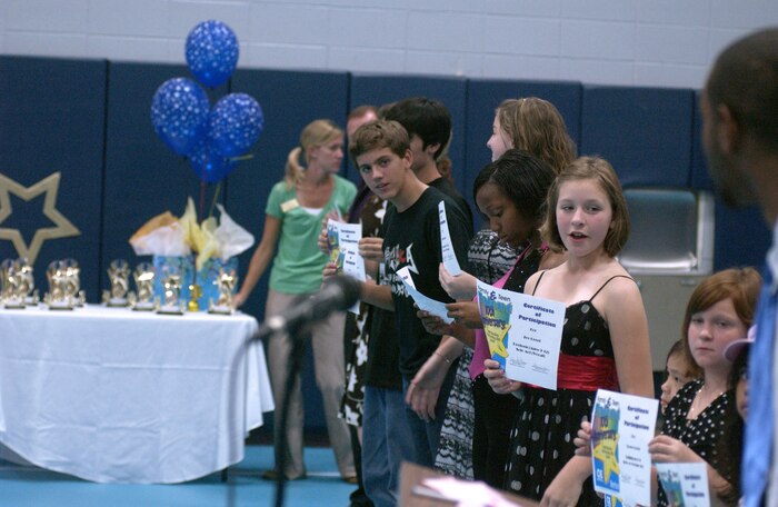 Family members and teens are awarded trophies and certificates for their performances at the 2007 Family and Teen Talent Contest. (U.S. Air Force photo/Tech. Sgt. Paul Kilgallon)                           