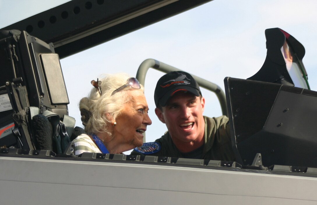 Ms. Betty Blake, one of the original Women Air Force Service Pilots who served during World War II, watches as Capt. Leo Lemelson, F-22A Aerial Demonstration Team safety observer, explains the inner workings of the Raptor during the Ohio air show Sept. 30. According to Ms. Blake’s son, George, she started flying at 14 without her parents’ knowledge because they wouldn’t have allowed her to be a pilot. Ms. Blake spent all four years of the war as a transport pilot ferrying 36 different types of aircraft including the P-51. Ms. Blake was one of 51 legendary aces, veterans, WASPs and crew chiefs honored at The Gathering of Mustangs and Legends in Columbus, Ohio, Sept. 27-30. (U.S. Air Force photo/Capt. Tracy Bunko)