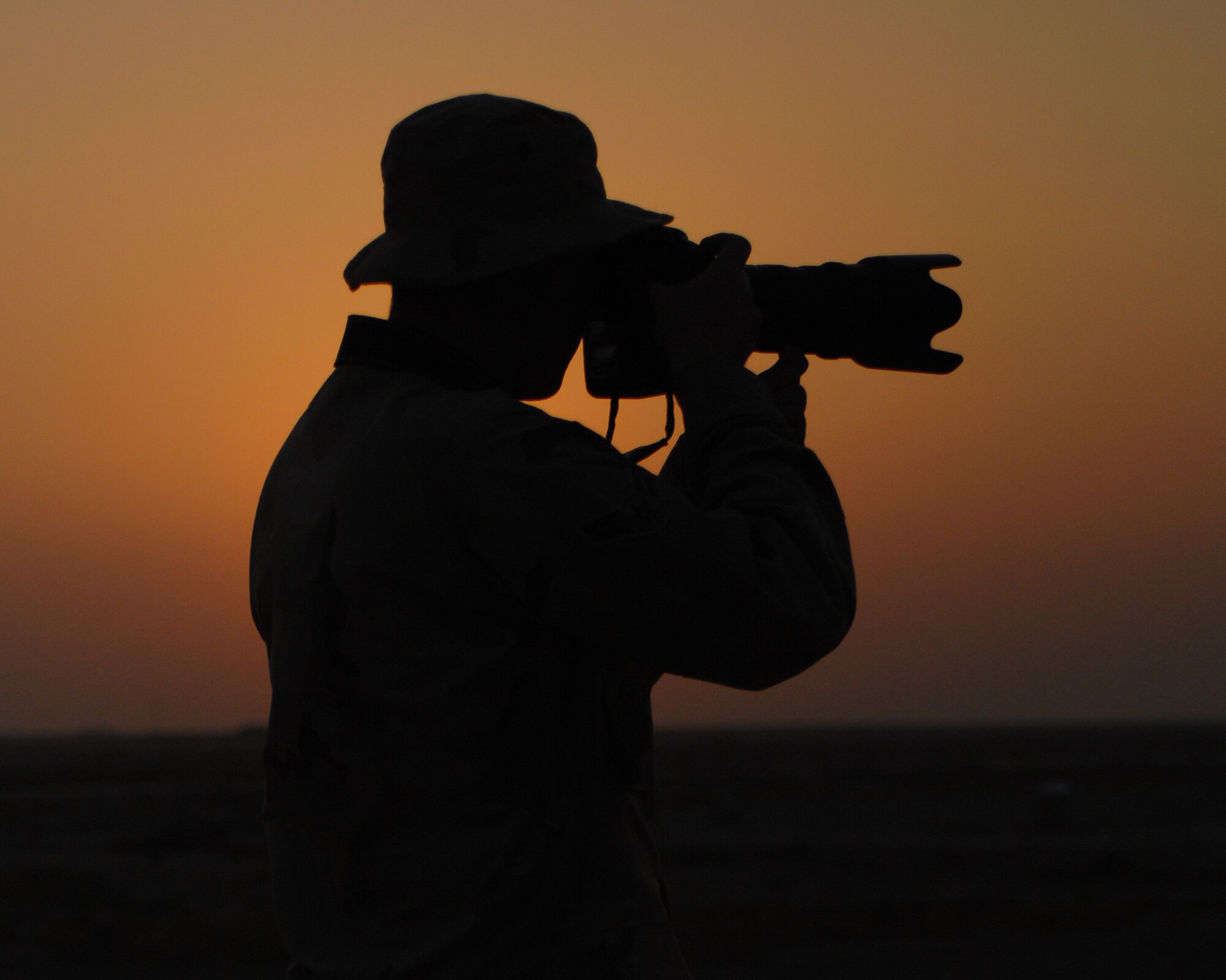 Ali Air Base, Iraq -- Airman 1st Class Jonathan Snyder, 407th Air Expeditionary Group Public Affairs, captures photographs of flightline operations Oct. 3 at Ali Air Base, Iraq. Airman Snyder documents day to day missions on base to spread the Air Force message to the public. (U.S. Air Force photo by Master Sgt. Rob Wieland) (Released)