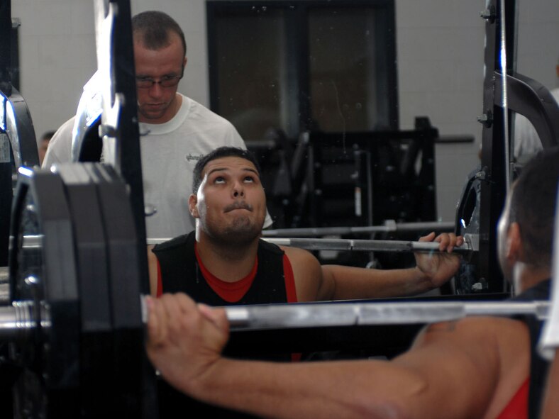 DYESS AIR FORCE BASE, Texas-- Senior Airman Albert Carrasquillo, 7th Equipment Maintenance Squadron, peforms a squat during a powerlifting competition at the Fitness Center's weight room Sept. 27. (U.S. Air Force Photo By Senior Airman Domonique Simmons)