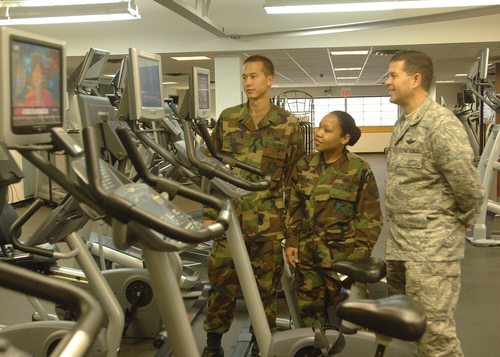 GRAND FORKS AIR FORCE BASE, N.D. -- Col. John Scorsone, the wing's new vice commander, talks with Airman 1st Class Michael Hurd and Senior Airman Shayna Mullin during a tour of the fitness center Sept. 27. Colonel Scorsone asked the Airmen about the facility and programs, both existing and planned. (U.S. Air Force photo/Airman 1st Class Chad Kellum)