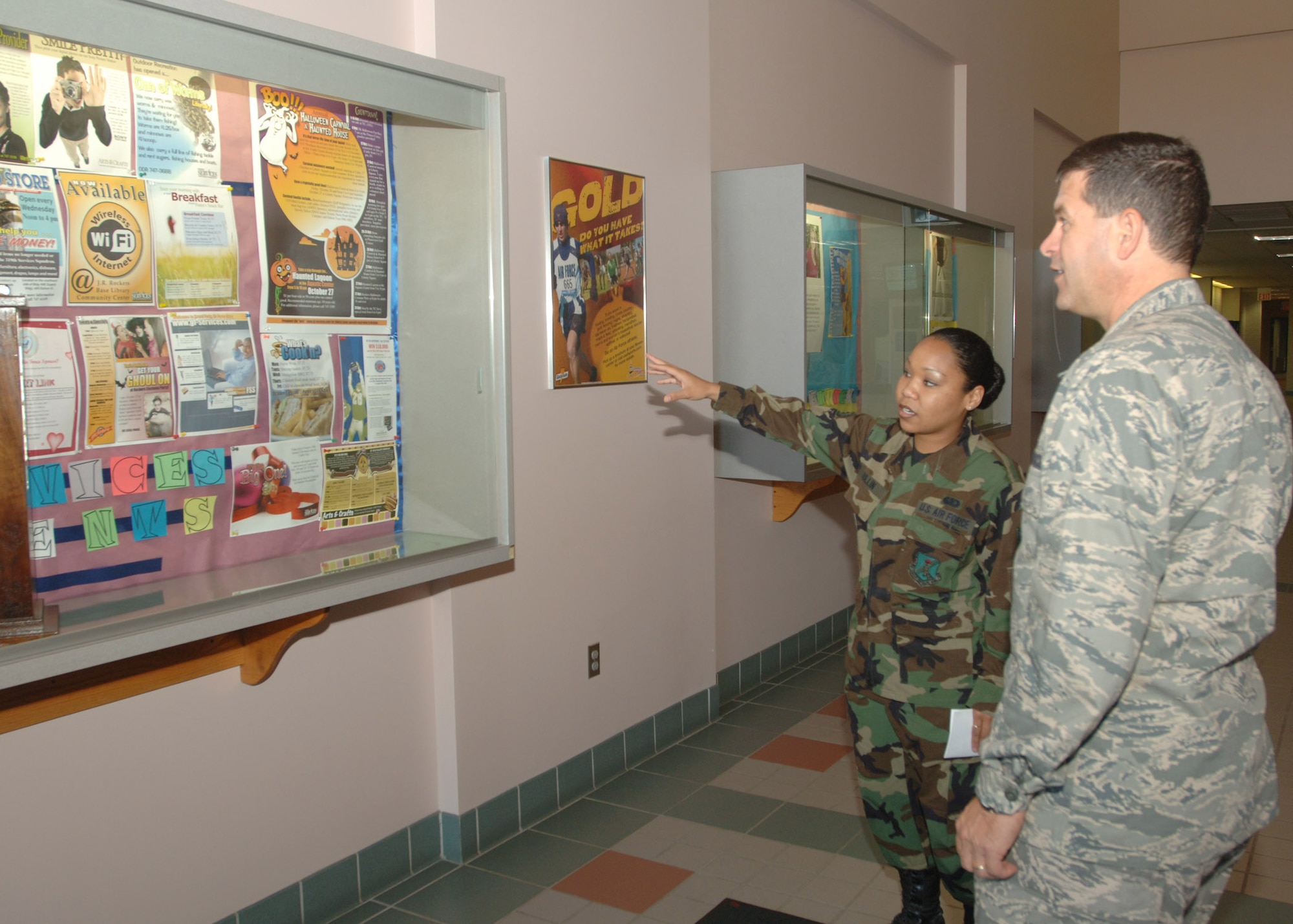 GRAND FORKS AIR FORCE BASE, N.D. -- Senior Airman Shayna Mullin, 319th Mission Support and Services Squadron, shows Col. John Scorsone, 319th Air Refueling Wing Vice Commander, a board showing the events available at the fitness center. Colonel Scorsone toured the fitness center to meet the staff and get a feel for what the fitness center offers Airmen, as well as what the center might need. (U.S. Air Force photo/Airman 1st Class Chad Kellum)