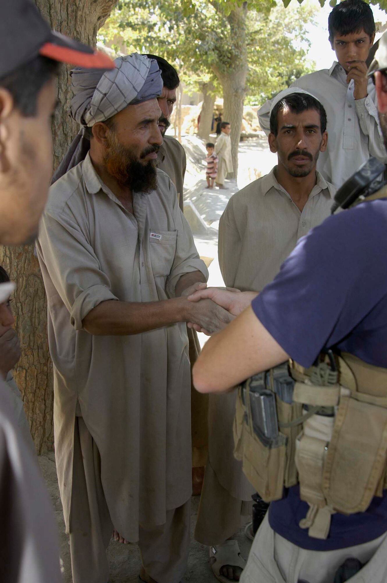 BAGRAM AIRFIELD, Afghanistan -- Village elders thank OSI agents after receiving school supplies during an humanitarian mission here. (U.S. Air Force photo by Staff Sgt. Mike Andriacco)