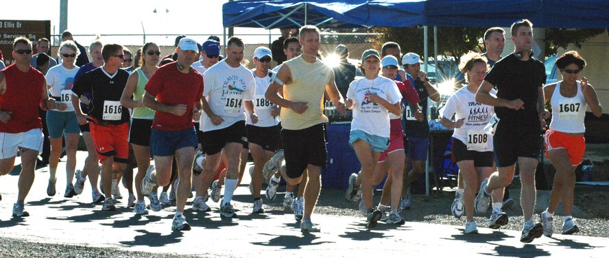 Runners take off from the starting line near Outdoor Recreation during the half marathon Sept. 29. Team Travis members and their families took part in the marathon that covered various parts of the base. (U.S. Air Force photo/Tech. Sgt. Donald Osborn)
