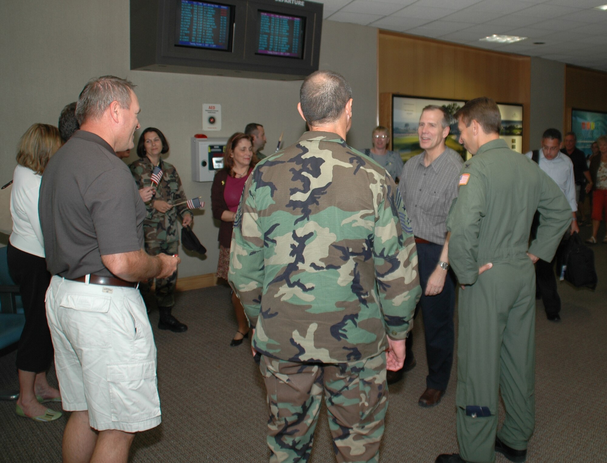 Col. Tim Wrighton, commander of the 315th Airlift Wing, Charleston AFB, S.C., is greeted by members of the wing after returning from a 4-month deployment to the Middle East.  (Photo by Capt. Wayne Capps, USAFR)