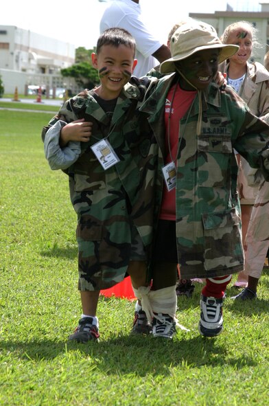 A Skoshi Warrior brings his “injured” buddy to safety in a three-legged race, Sept. 29. Other obstacle course activities included a low-crawl, rifle carry and a Nerf ball shooting range.
(U.S. Air Force/Senior Airman Nestor Cruz)
