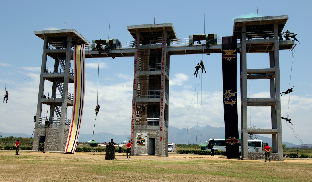 Colombian Special Forces members put on a demonstration for U.S. Defense Secretary Robert M. Gates while he takes a tour of Tolemaida Air Base during a trip to Bogota, Colombia, Oct. 3, 2007.  