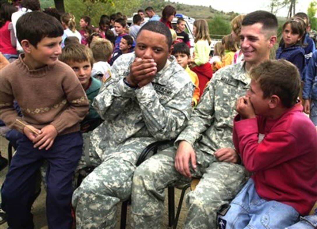 U.S. Army Spc. Curtis Brown, of 29th Infantry Division, teaches students how to perform a beat box during their visit to a primary school in Kosovo, Serbia, Oct. 1, 2007. 