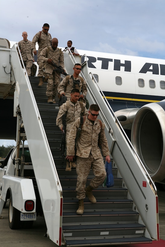 Marines assigned to 1st Battalion, 12th Marine Regiment and Marine Heavy Helicopter Squadron 362 get off the plane after landing at Hangar 105 here on Wednseday.