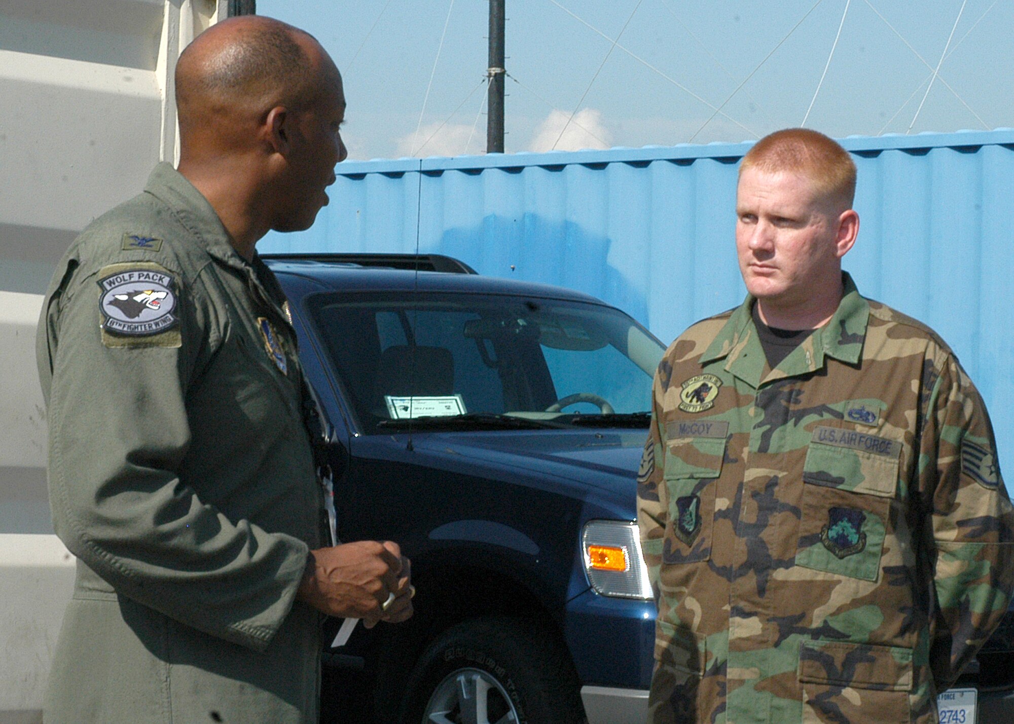 KUNSAN AIR BASE, South Korea -- Colonel CQ "Wolf" Brown, 8th Fighter Wing commander, congratulates Staff Sgt. Jeffrey McCoy from the 35th Aircraft Maintenance Unit, here Sept. 25. Sergeant McCoy was selected as the 8th Fighter Wing's Pride of the Pack for the week of Sept. 24. (U.S. Air Force photo/Staff Sgt. Araceli Alarcon)       