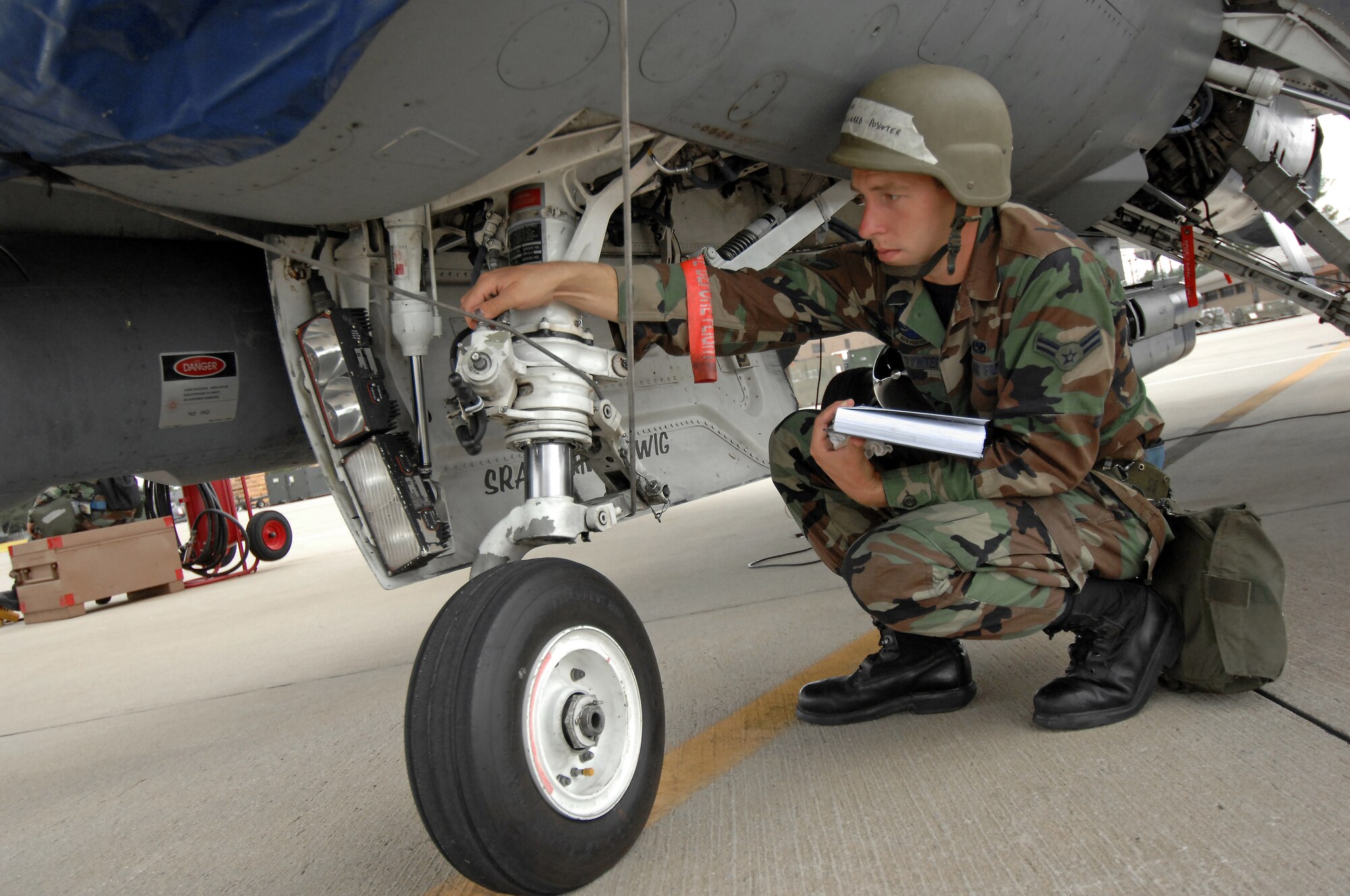 SHAW AIR FORCE BASE, S.C. -- Airman 1st Class Richard Poynter, 55th Aircraft Maintenance Unit, checks the integrity of landing gear during an operational readiness exercise Oct. 4. An ORE prepares Airmen in deployment procedures. (U.S. Air Force photo/Airman 1st Class Kathrine McDowell)