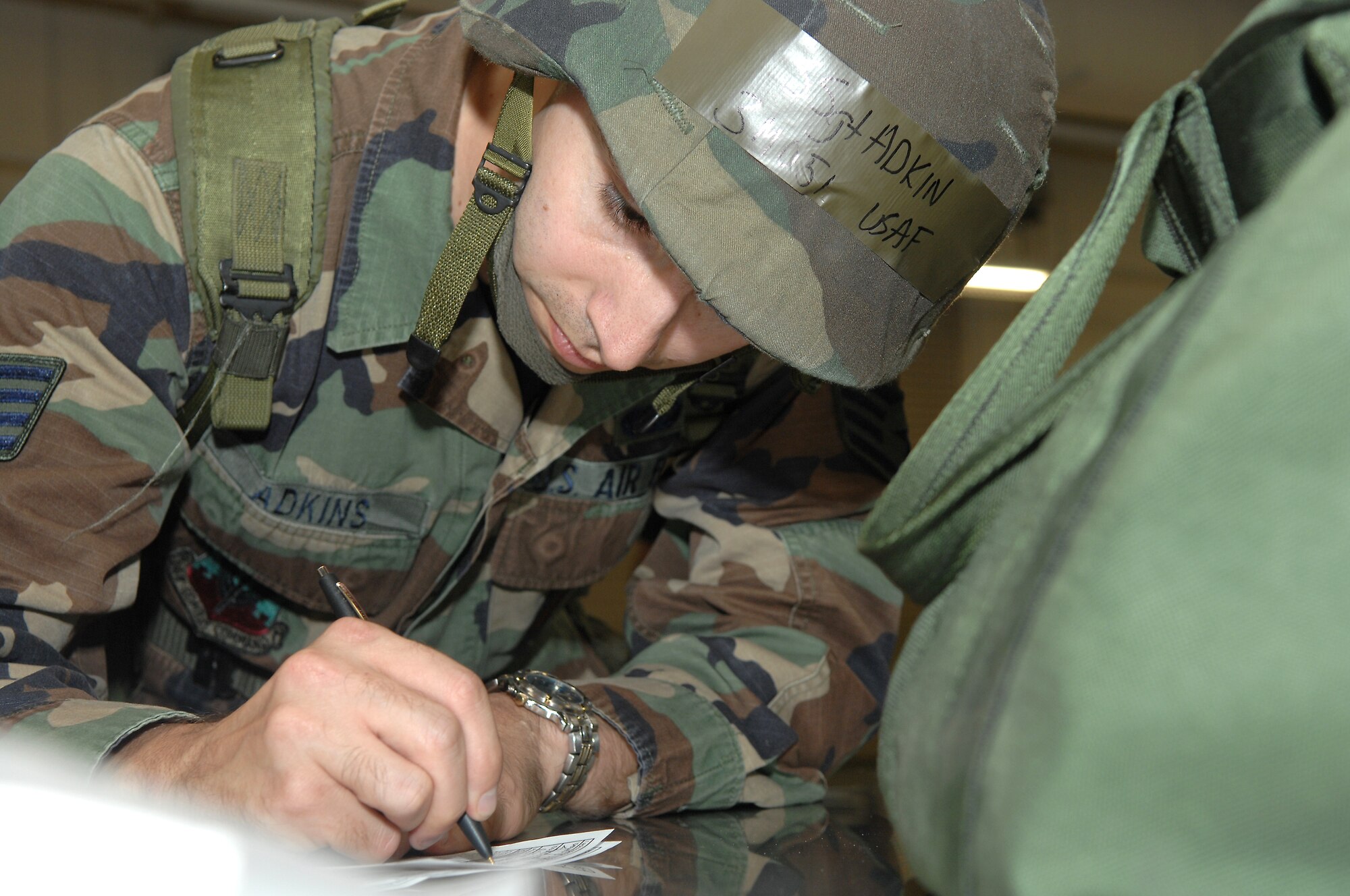 SHAW AIR FORCE BASE, S.C. -- Staff Sgt. Benjamin Adkins, 20th Services Squadron food specialist, fills out a hand receipt for chemical warfare gear at the Chandler Deployment Processing Center during an operational readiness exercise Oct. 4.  The ORE is designed to ensure Airmen are ready and able to deploy at a moment's notice. (U.S. Air Force photo/Staff Sgt. Nathan Bevier)
