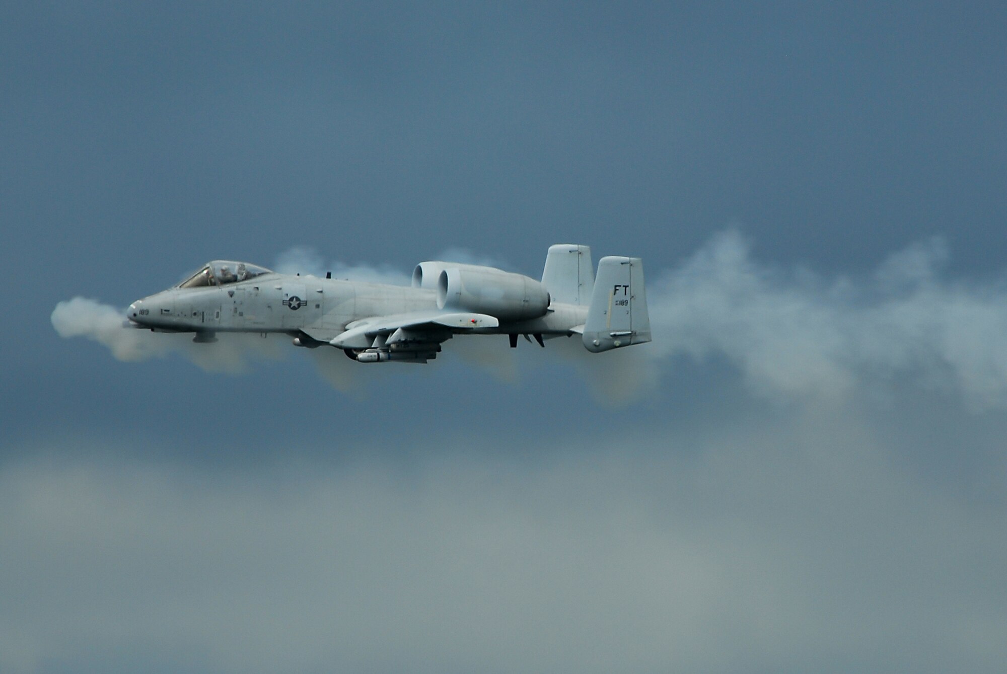 MOODY AIR FORCE BASE, Ga. -- An A-10C Thunderbolt II ground attack aircraft performs a low-level strafing run with its 30 mm cannon during a combat search and rescue demonstration here Oct. 4.  The digitally-upgraded A-10C has been equipped with satellite-guided precision weaponry and advanced communications data links for transferring information with ground-based warfighters. (U.S. Air Force photo by Tech. Sgt. Parker Gyokeres)