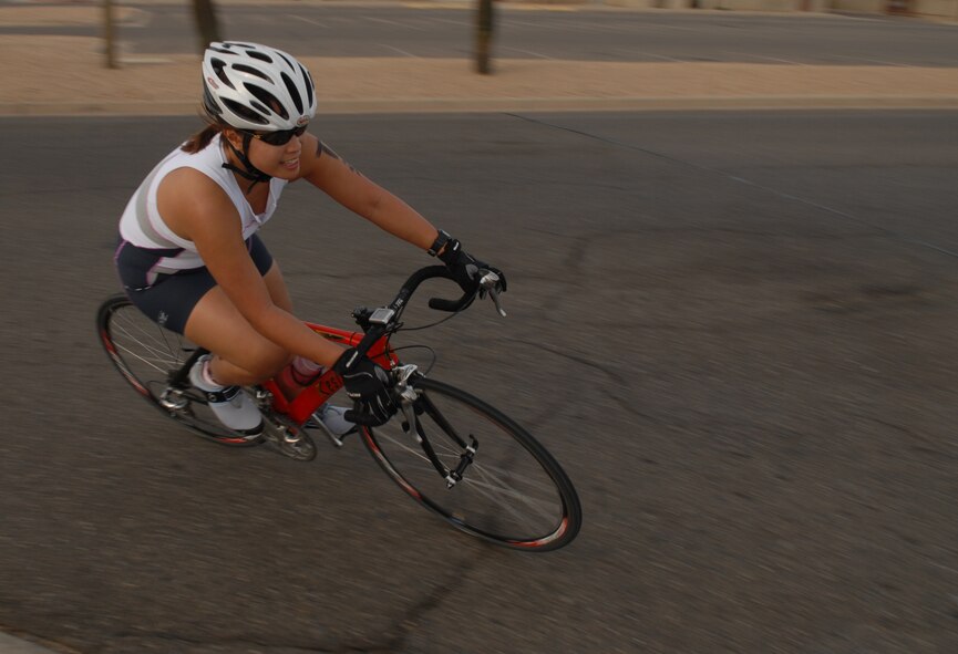 A Thunderbolt speeds along Phantom Street as she competes in the Luke Fitness Center Fall Triathlon Saturday. Winner of the over-40 male category was David Flory, No. 15, with a time of 66:20. Winner of the over-40 female category was Debbie Belanger, No. 34, with a time of 72.33. Winner of the team category was A.N.T. with a time of 62:44. (photo by Airman 1st Class Gustavo Gonzalez)