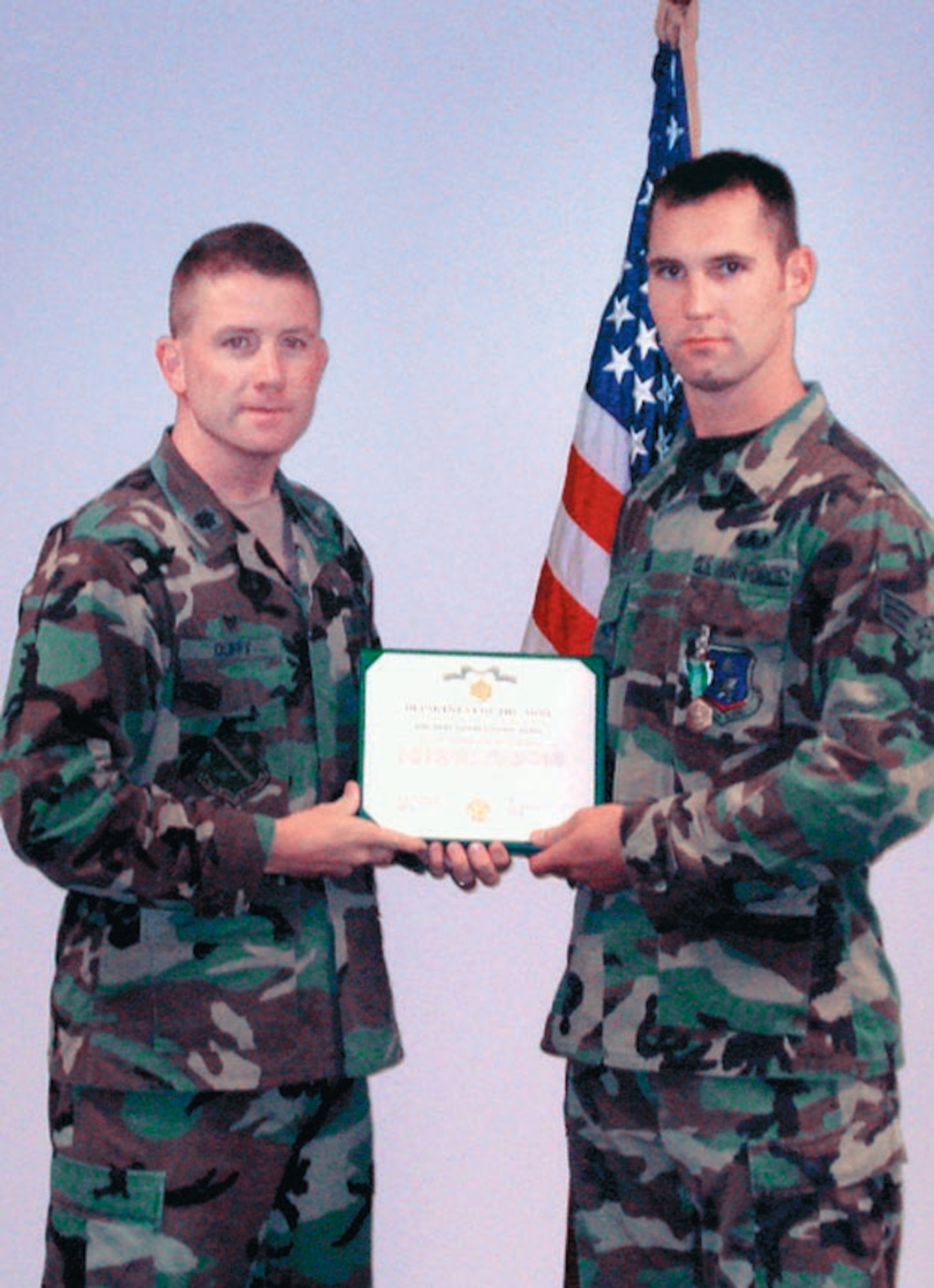 Lt. Col. Brian P. Duffy stand withs Senior Airman Delbert Guile after presenting him the Army Commendation Medal, June 25. (Courtesy Photos)