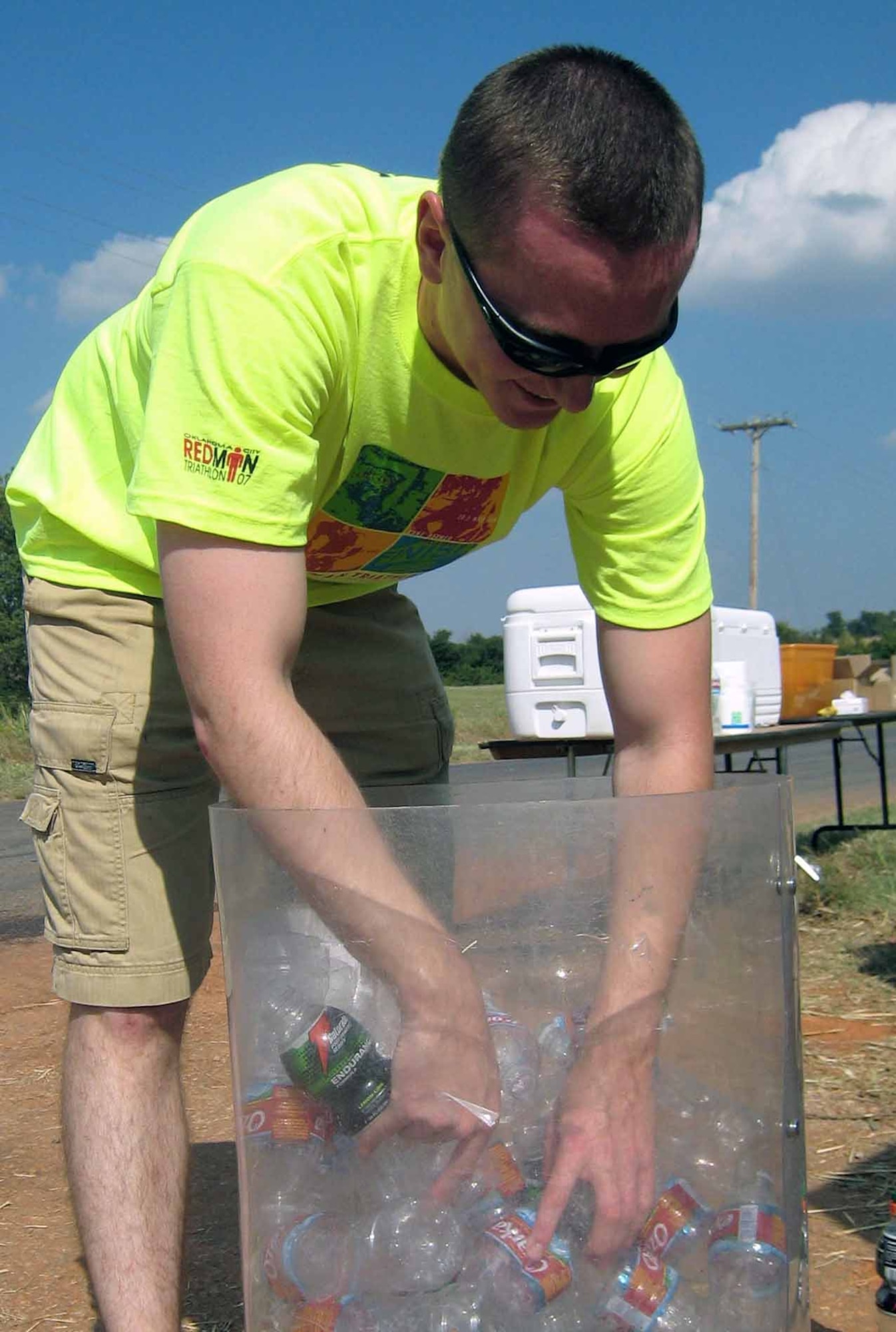 Matthew Cook, a second lieutenant in the 552nd Training Squadron, searches for the coldest drinks for the runners. (Air Force photo by Senior Airman Zach Anderson)