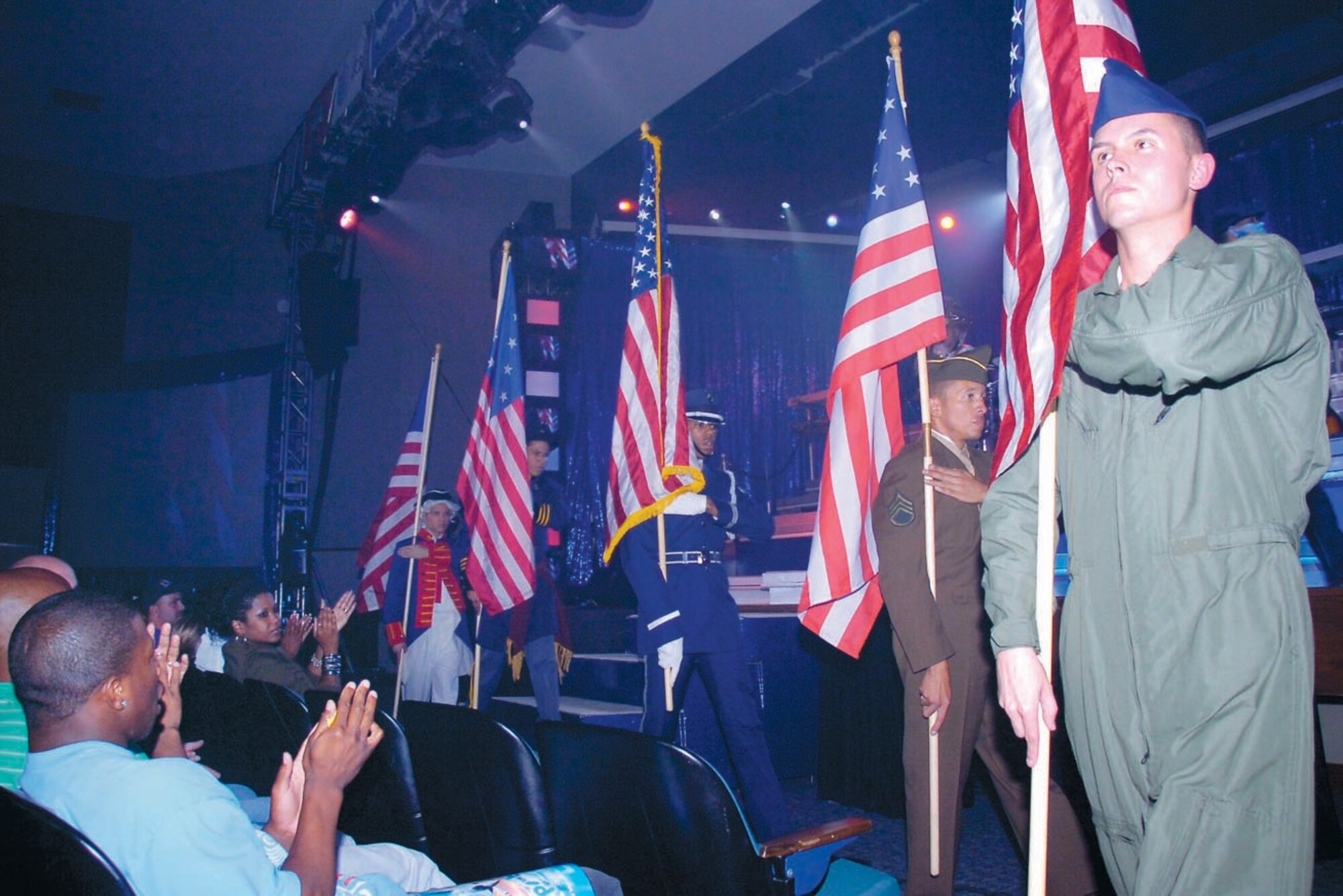 Tops In Blue members dressed in military period uniforms parade the U.S. flags during a musical and historical tribute during the show Sept. 28.  (US Air Force/Bobby Jones)