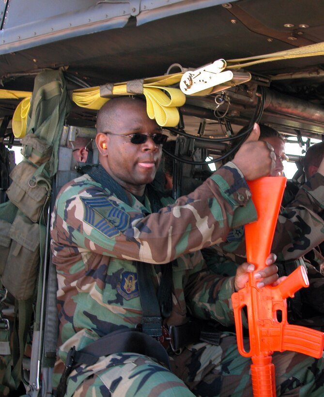 Air Force Reservist Chief Master Sgt. Curtis Coleman, 908th Security Forces Squadron, gives the thumbs up sign prior to take off in an Army UH-60A Black Hawk helicopter. The security forces manager and aerial port specialists from the 908th Airlift Wing's 25th Aerial Port Squadron were among the 240+ Reservists and active duty Airmen from Maxwell AFB participating in an exercise involving two UH-60A Black Hawk Army helicopters and their aircrews practicing sling loading and tactical troop transport near the Maxwell AFB flightline Sept. 10. (U.S. Air Force Photo by Lt. Col. Jerry Lobb)         
