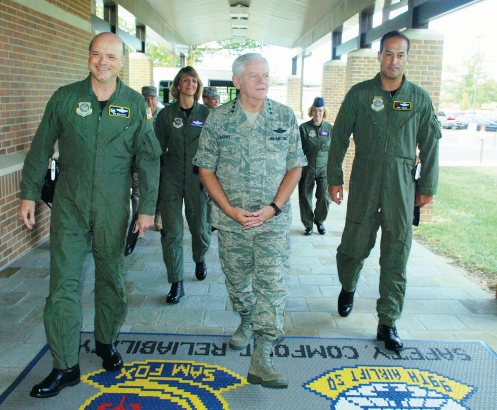Gen. Arthur Lichte, commander, Air Mobility Command, Col. James Wolcott, 89th Operations Group commander, left, Brig. Gen. Margaret Woodward, 89th Airlift Wing commander, rear, and Lt. Col. Robert Holba, 89 OG deputy commander, right, enter the 99th Airlift Squadron's Squadron Operations Building during his tour of the 89 AW, Sept. 28. (US Air Force/A1C Renae Kleckner)