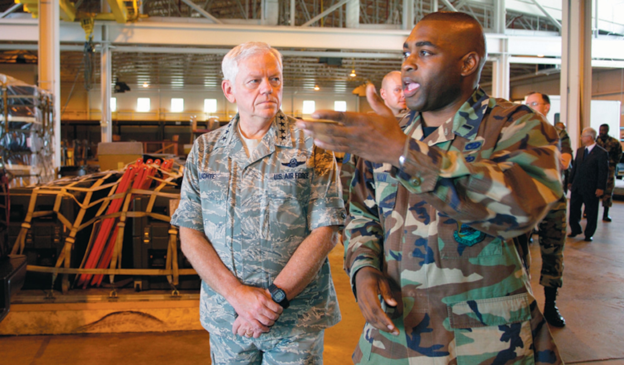 1st Lt. Eric Mason of the 89th Aerial Port Squadron briefs Gen. arthur Lichte, commander, Air Mobility Command, during a tour of the loading bays in bldg. 1900, Sept. 28. (US Air Force/A1C Renae Kleckner)