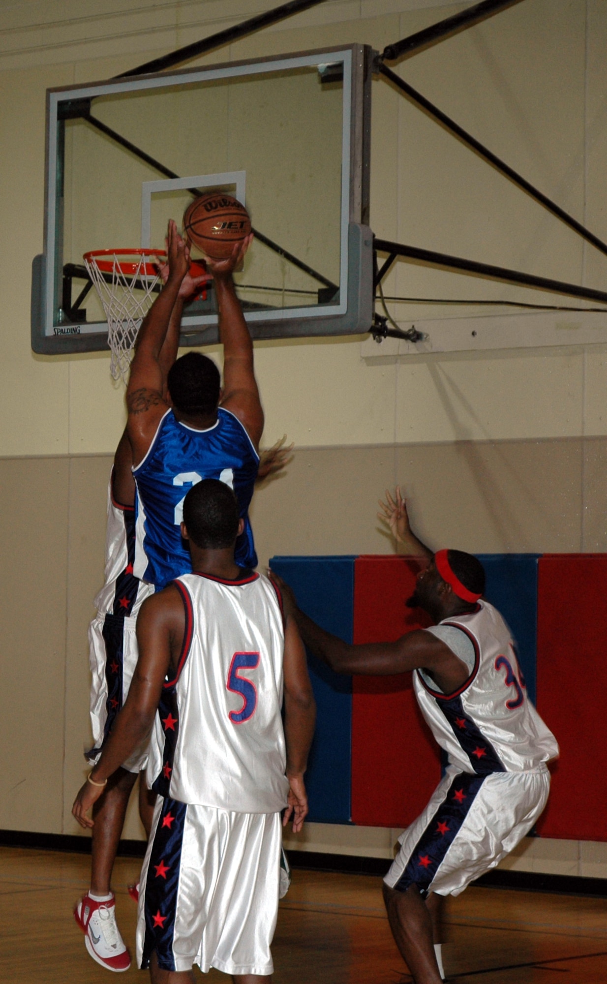Malmstrom "B" team forward Steve Schepel, #21, goes up for a shot against members from the Nellis Air Force Base team during game two of the Fall Classic Basketball Tournament hosted by Malmstrom Sept. 28 to 30. The event was sponsored, in part, with funds provided by the Enforcing Underage Drinking Laws committee as an alternative activity that doesn't involve alcohol consumption. (U.S. Air Force photo/Airman 1st Class Emerald Ralston)