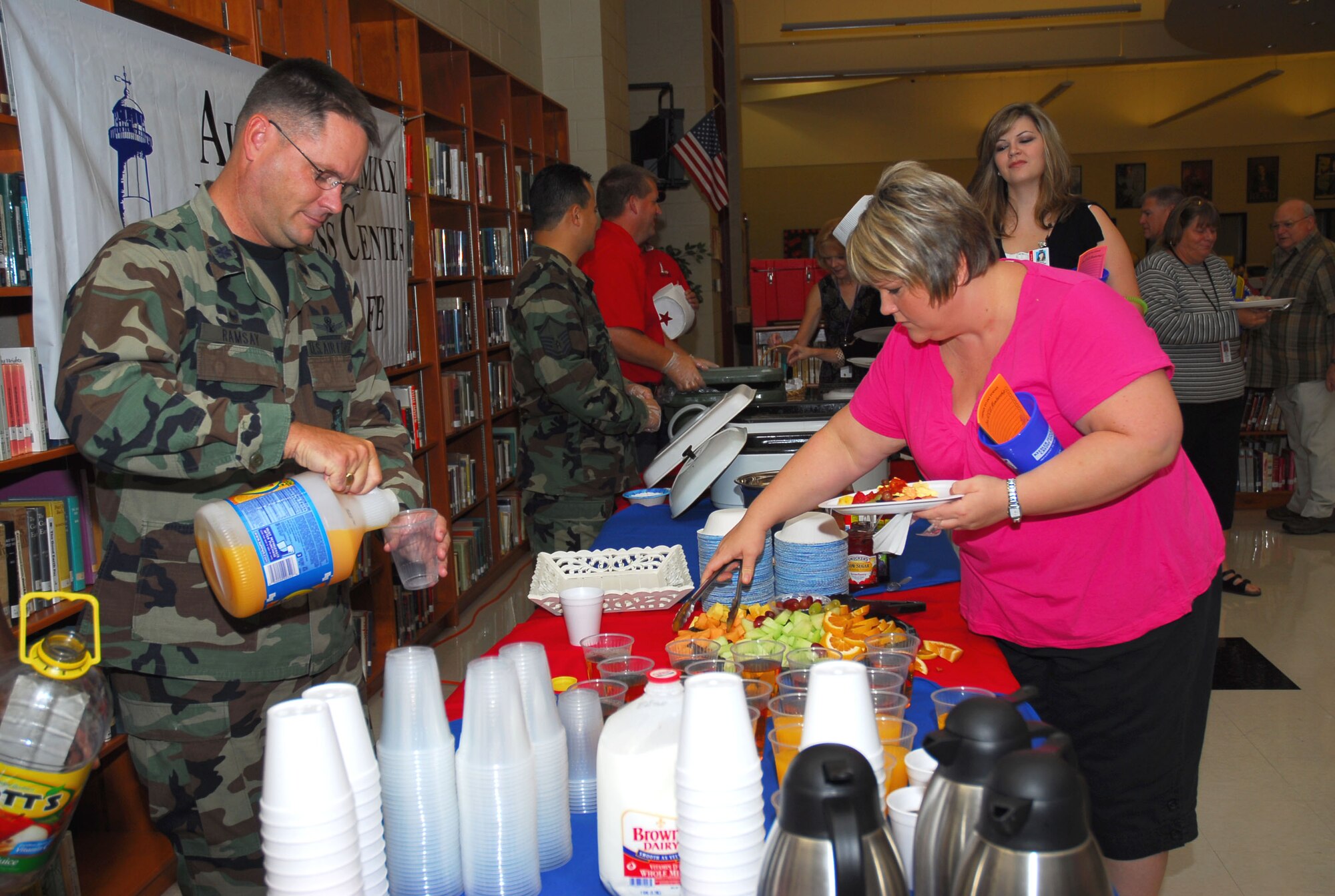 Lt. Col. Steven Ramsay,  left,  332nd Training Squadron  commander, and Kelly Norris, a Biloxi High School Spanish and drama teacher, enjoy a breakfast  sponsored by Keesler  Oct. 4.  Biloxi High School, attended by many Keesler students, was one of four schools recognized by the U.S. Department of Education as Blue Ribbon Schools.  Blue Ribbon Schools are noted for their academic superiority or demonstrate dramatic gains in student achievement.  (U.S. Air Force photo by Kemberly Groue)