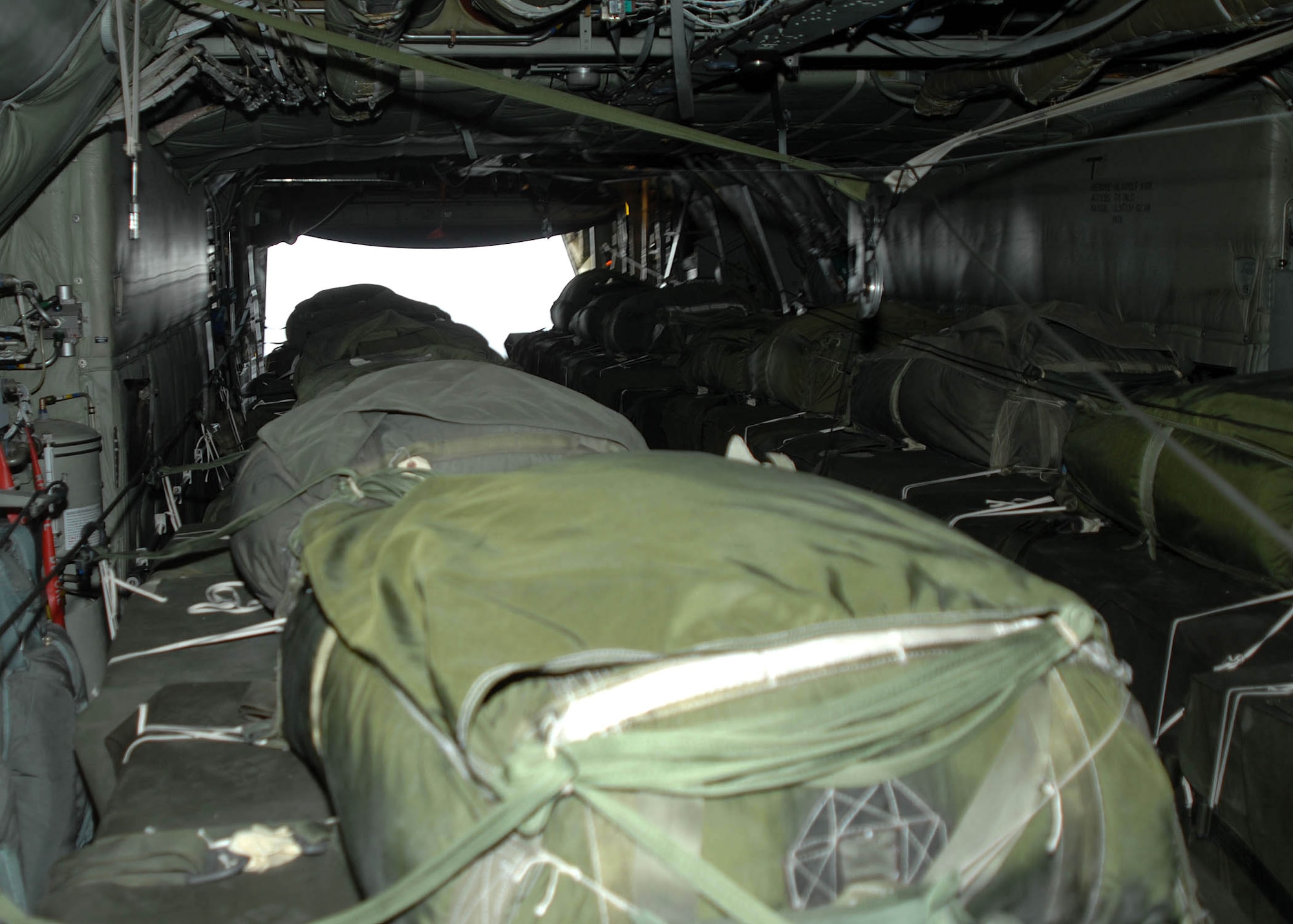 The ramp cargo door opens over a drop zone to release bundles of supplies being airdropped from a C-130 Hercules to troops in the field by the 774th Expeditionary Airlift Squadron from Bagram Air Base, Afghanistan. The airdrop crew are Air National Guard with the 165th Airlift Wing from Louisville, Ky., and the 109th Airlift Wing from Schenectady, N.Y. (U.S. Air Force photo/Senior Master Sgt. Kim Allain)
