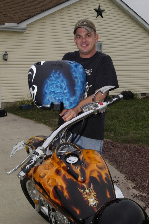 Staff Sgt. Randy Long, 436th Aerial Port Squadron, shows off his latest project and stands in front of a motorcycle with ‘true fire.’ (U.S. Air Force photo/Airman Shen-Chia Chu)                         