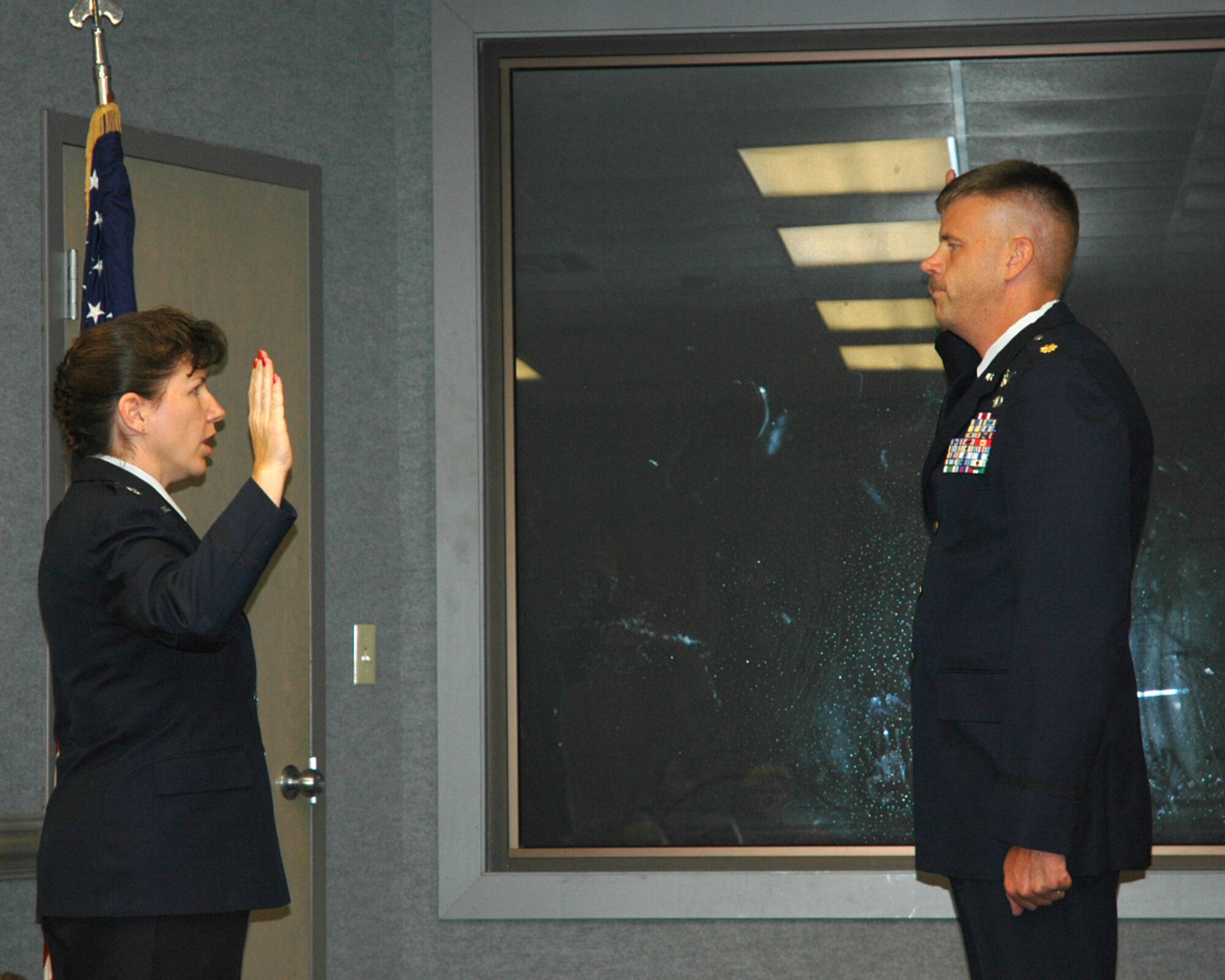 TYNDALL AIR FORCE BASE, Fla. -- Lt. Col. David "DavO" Omstead, 53d Weapons Evaluation Group Standardization and Evaluation Officer, is administered the Oath of Office by his wife, Lt. Col. Barbara Omstead, 81st Range Control Squadron commander, Sept. 28. The new colonel serves as a Senior Air Battle Manager in the U.S. Air Force Reserves. The couple have been married more than 13 years and have 3 children. (US Air Force photos/ Senior Airman Kristen Gonzalez)